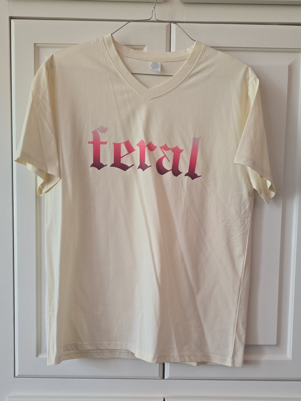 Feral Graphic V‑Neck Tee in Cream and Pink